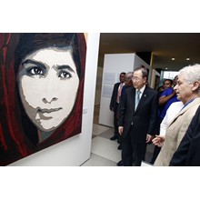 United Nations Secretary-General Ban Ki-moon listens to painter and curator  Fabrizio Ruggiero introducing the fresco portrait of Malala Yousafzai (Pakistan) , part of the exhibit " The transformative Power of Art" at United Nations Visitors Lobby, New York. 30 June   2015