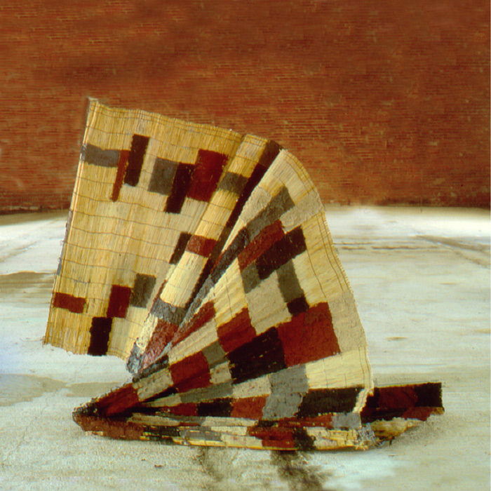  Flying carpet Wood, cane mat, mortar, pigments.Cm. 250x160x80.